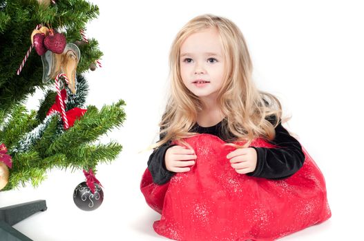 Beautiful baby girl dressed up for Christmas isolated in white