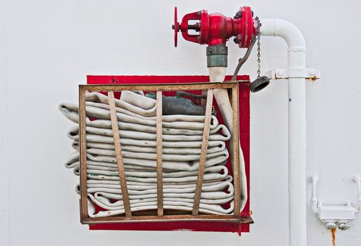 A fire hose stored on a wall