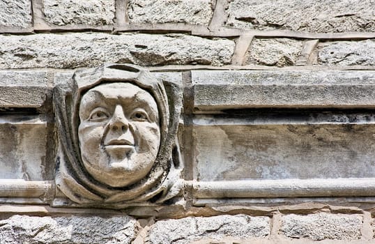 A face embedded in the architecture of a building wall