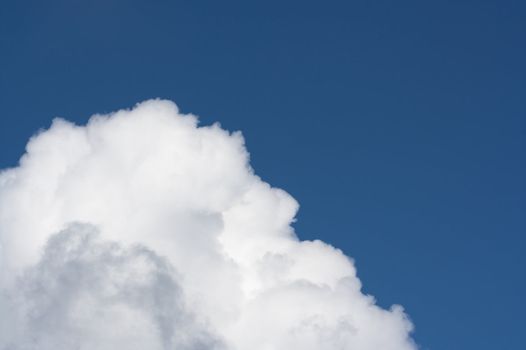 A big fluffy cumulus cloud in a blue sky