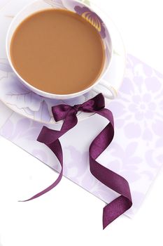 Cup of cappuccino blank note and violet ribbon