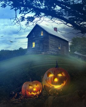 Halloween pumpkins in front of a Spooky house