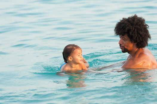 First time swimming lesson with proud daddy