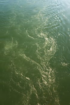 Green flowing water background texture pattern.