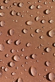 Drops of water on waterproof tent fabric.