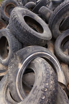 Pile of old tires and wheels for rubber recycling.