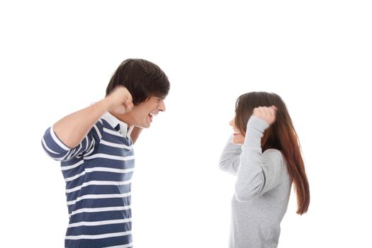 Young couple in conflict shouting each other, isolated on white background