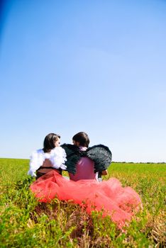 Young happy couple on the field. Shoot on the nature.