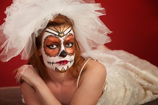 Woman Lying on Floor with Bridal Makeup for All Souls Day
