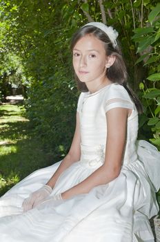 girl white dress the day of their first communion
