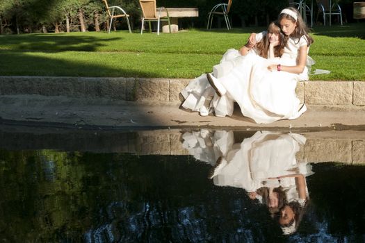 girls white dress the day of their first communion
