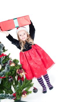 Beautiful baby girl dressed up for Christmas isolated in white