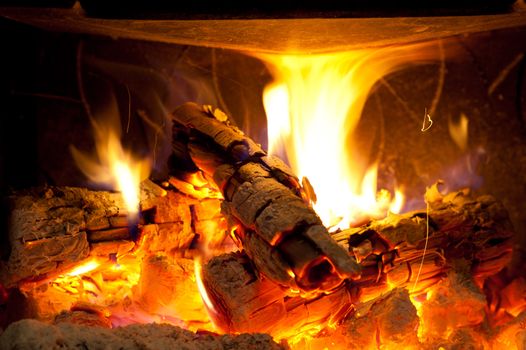 Burning logs in a cosy living room chimeney
