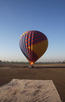 Hot air balloon heating up for take off,  Luxor Egypt