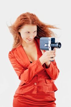 Young woman in red dress hold old video camera