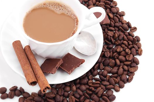 Cup of cappuccino, coffee beans, cinnamon and chocolate