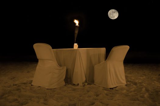 Romantic dinner table in the evening at a beach on Aruba