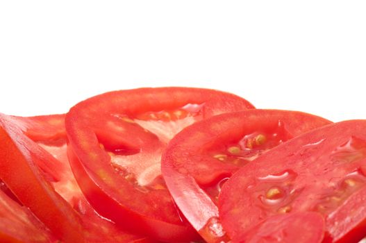 Cut tomato closeup on a white background.