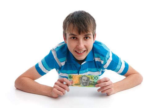 Boy holding a $100 Australian banknote and smiling.   