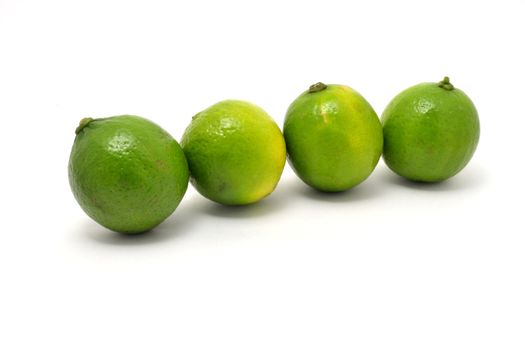 The fresh green limes over white background
