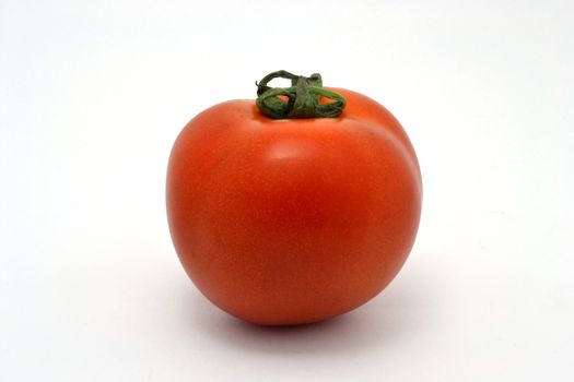 The single  tomato  over the white background