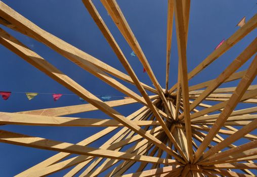 View of the wooden roof structure over clear  blue sky
