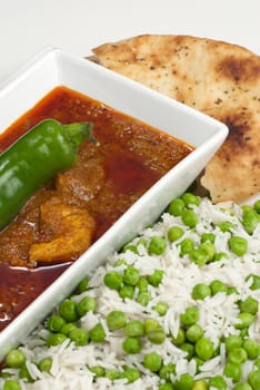 Chicken Madras curry served with rice and naan bread