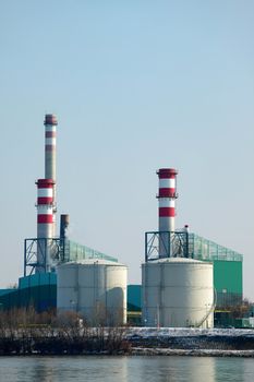 Power plant building against clear blue sky