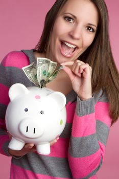 Woman taking piggy bank money