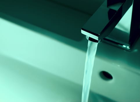 Closeup of modern bathroom tap in blue