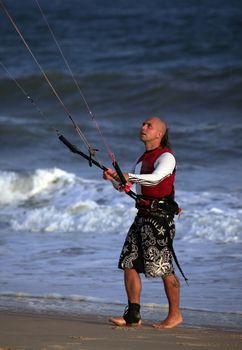 Kitesurfer with surferboard on the beach