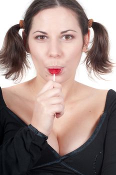 Portrait of pretty woman in black dress eating candy isolated on white