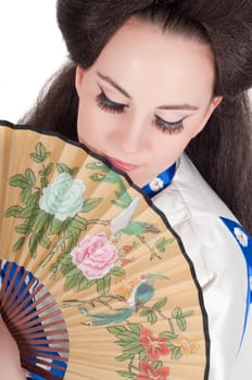 Portrait of the girl of the Asian appearance with a make-up under the geisha on a white background