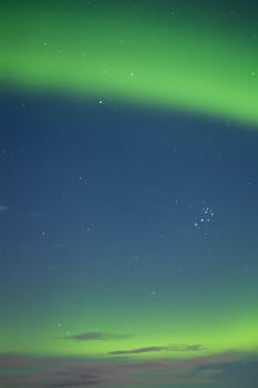 Intense Aurora borealis and stars in moon lit night.