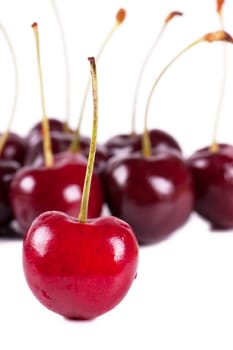 Close up view of fresh cherries over white background