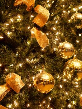 Background made of Christmas tree decorated with golden balls