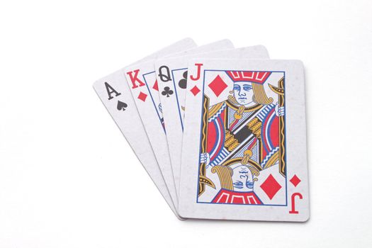 Gambling with playing cards over a white background.