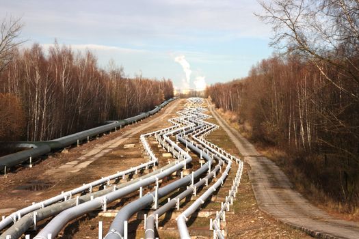 View of pipelines leading to the horizon with power-plant