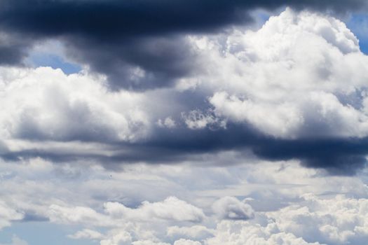 View of some fluffy stratocumulus clouds on a blue sky.