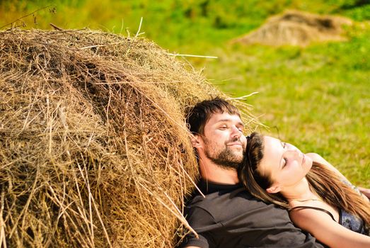 Young happy couple on the field. Shoot on the nature.