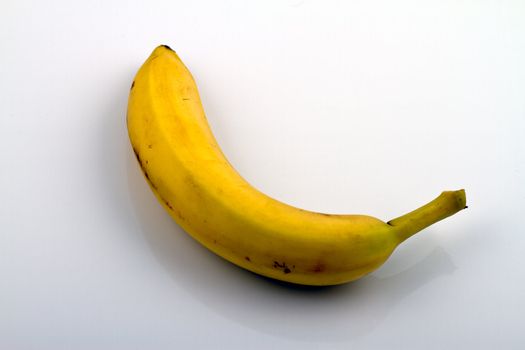 A banana on white semi reflecting background