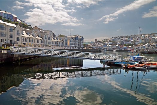 A new development on the left, complements the older parts of the town at Brixham in Devon, England.