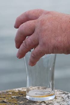 man picking up pint glass