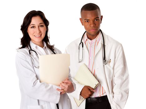 Attractive female doctor and handsome male physician medical team with white coats and stethoscopes standing holding patient file chart dossier, isolated.