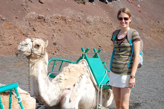 Young woman camel in timanfaya national park in lanzarote