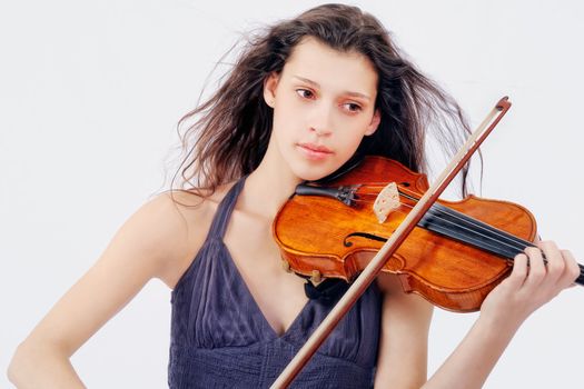 Young woman playing violin. Isolated on the white background
