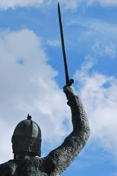 Bronze warrior with sword raised