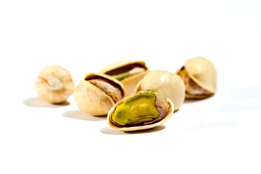 closeup image of pistachios on white background