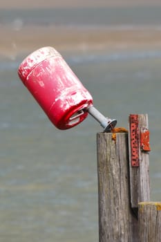 red bucket by estuary