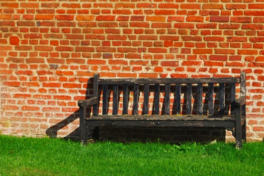 Bench with bricks in background